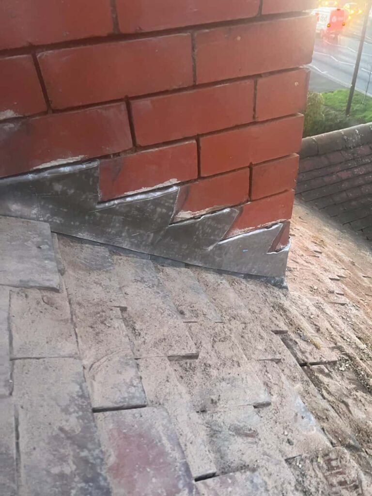 This is a photo of new leadwork being installed around an old chimney. Works carried out by Kingswinford Roofing Repairs